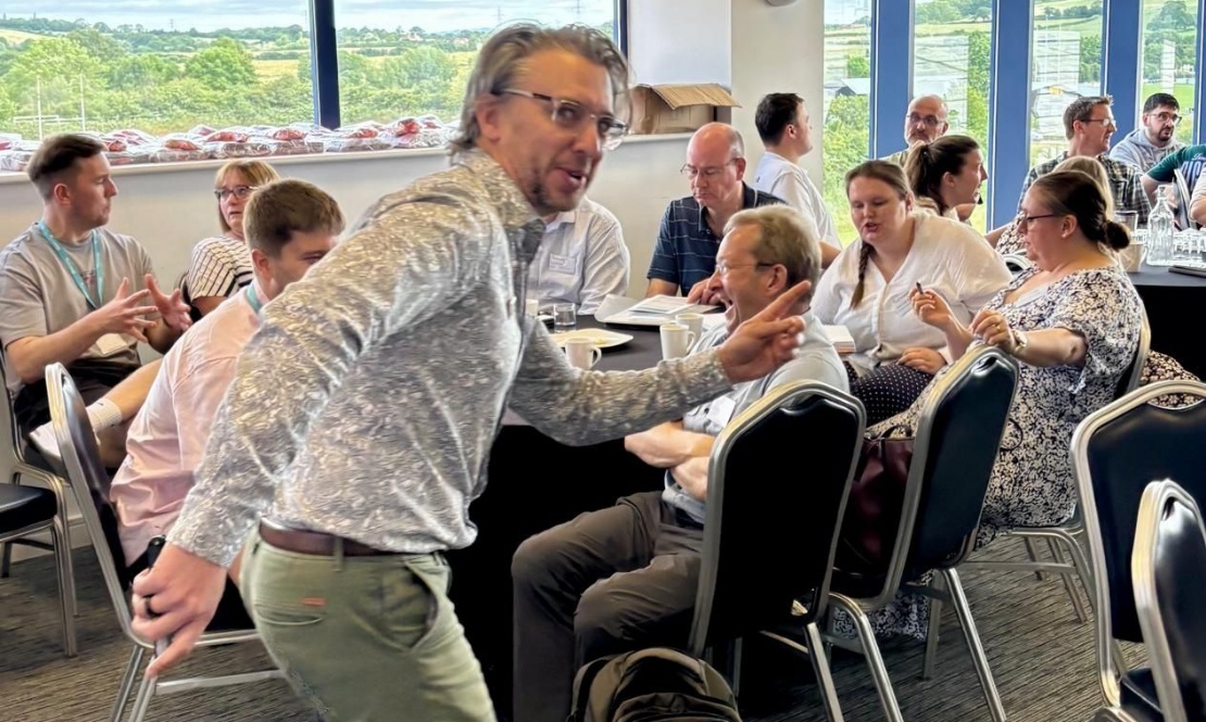 Photo of Tom Manners, keynote speake, presenting to delegates of GLOW Maths Hub's Secondary MathsFest conference
